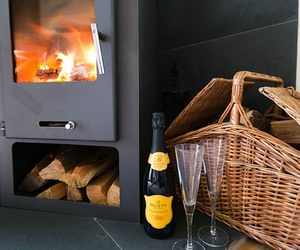 Duck House Bodorgan Anglesey champagne in front of fire 1920x1080