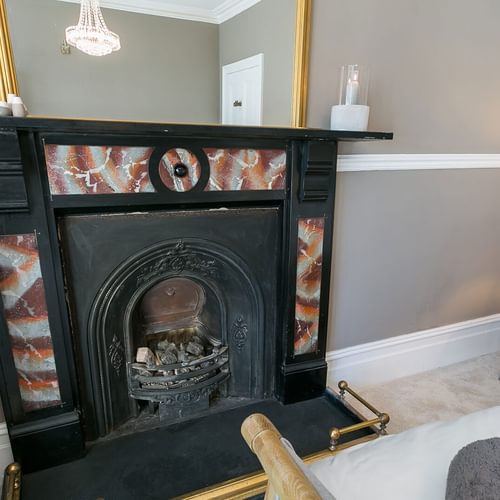 Craig Hyfryd Beaumaris Anglesey bedroom fireplace 1920x1080