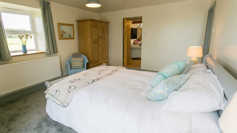 Boltholes and Hideaways Bettws Farmhouse Cemaes Bay bedroom 1 to sitting room