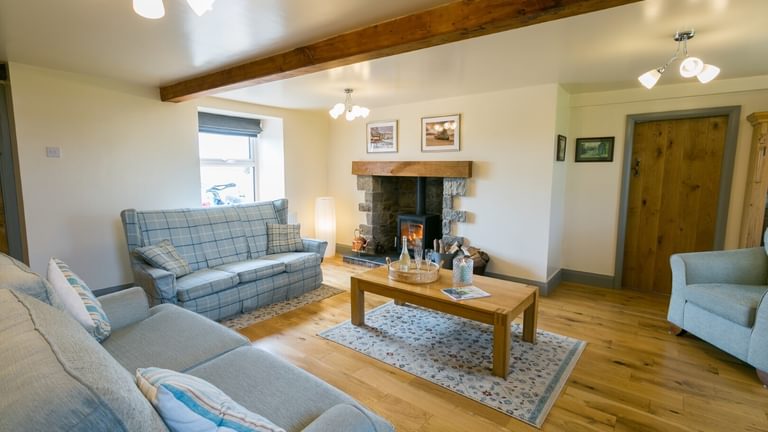 Boltholes and Hideaways Bettws Farmhouse Cemaes Bay sittting room across to fire