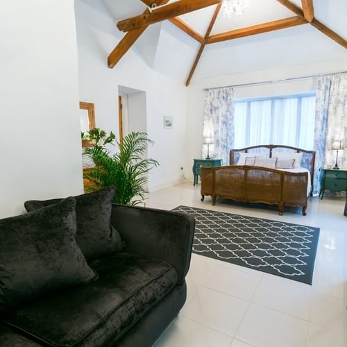 Boltholes and Hideaways Tal Y Bont Uchaf Stables Peregrine Suite sofa area to king bed 1620