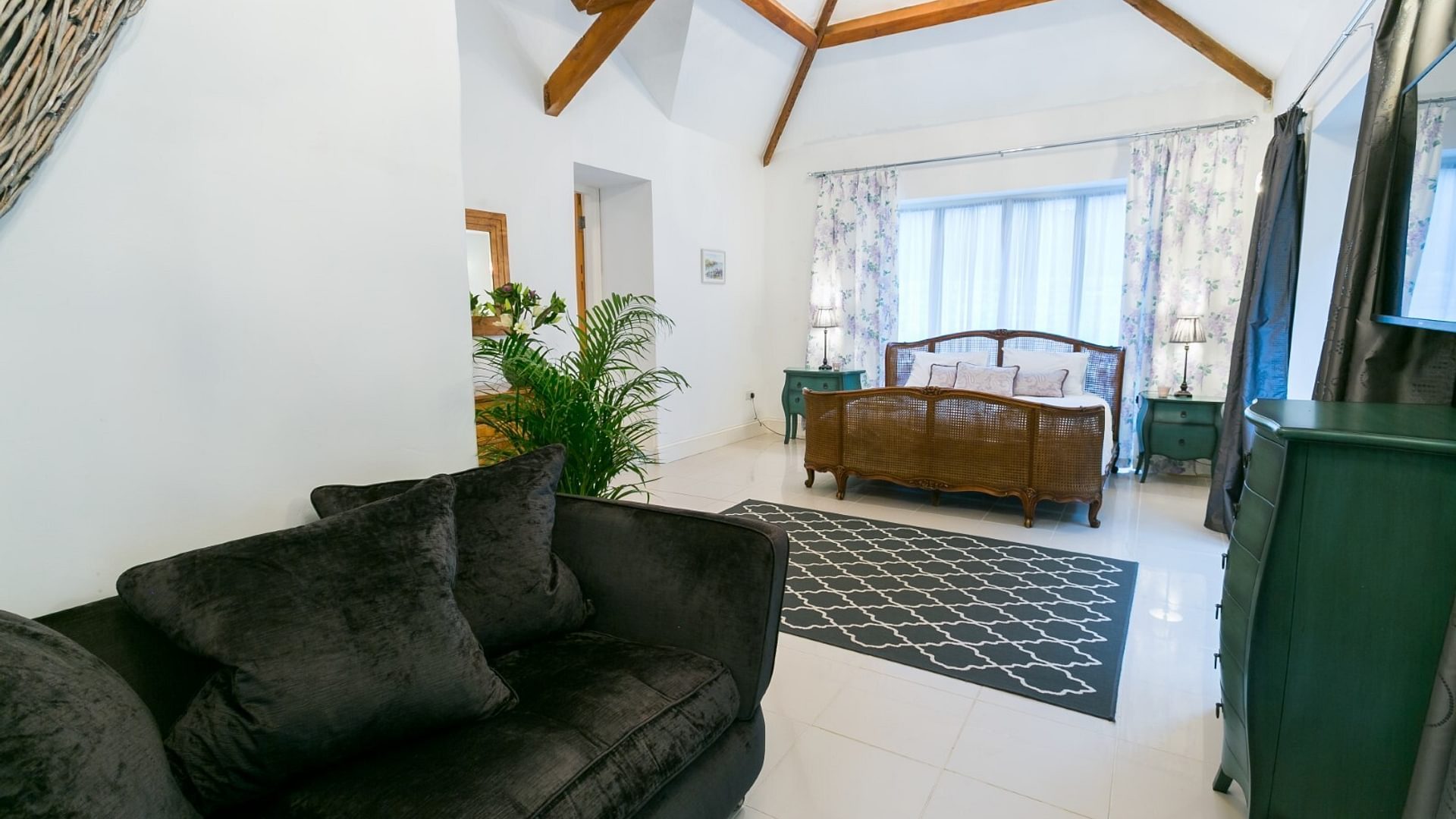 Boltholes and Hideaways Tal Y Bont Uchaf Stables Peregrine Suite sofa area to king bed 1620