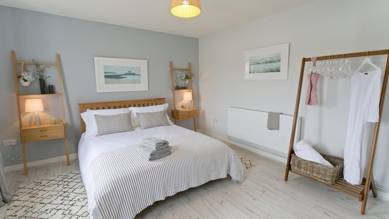 Boltholes and Hideaways Ty Glan Y Mor Aberffraw master bedroom hanging space