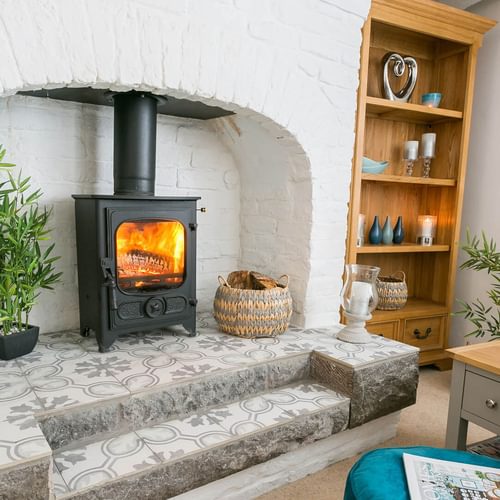 Gower Cottage Beaumaris Anglesey sitting room fireplace 1920x1080